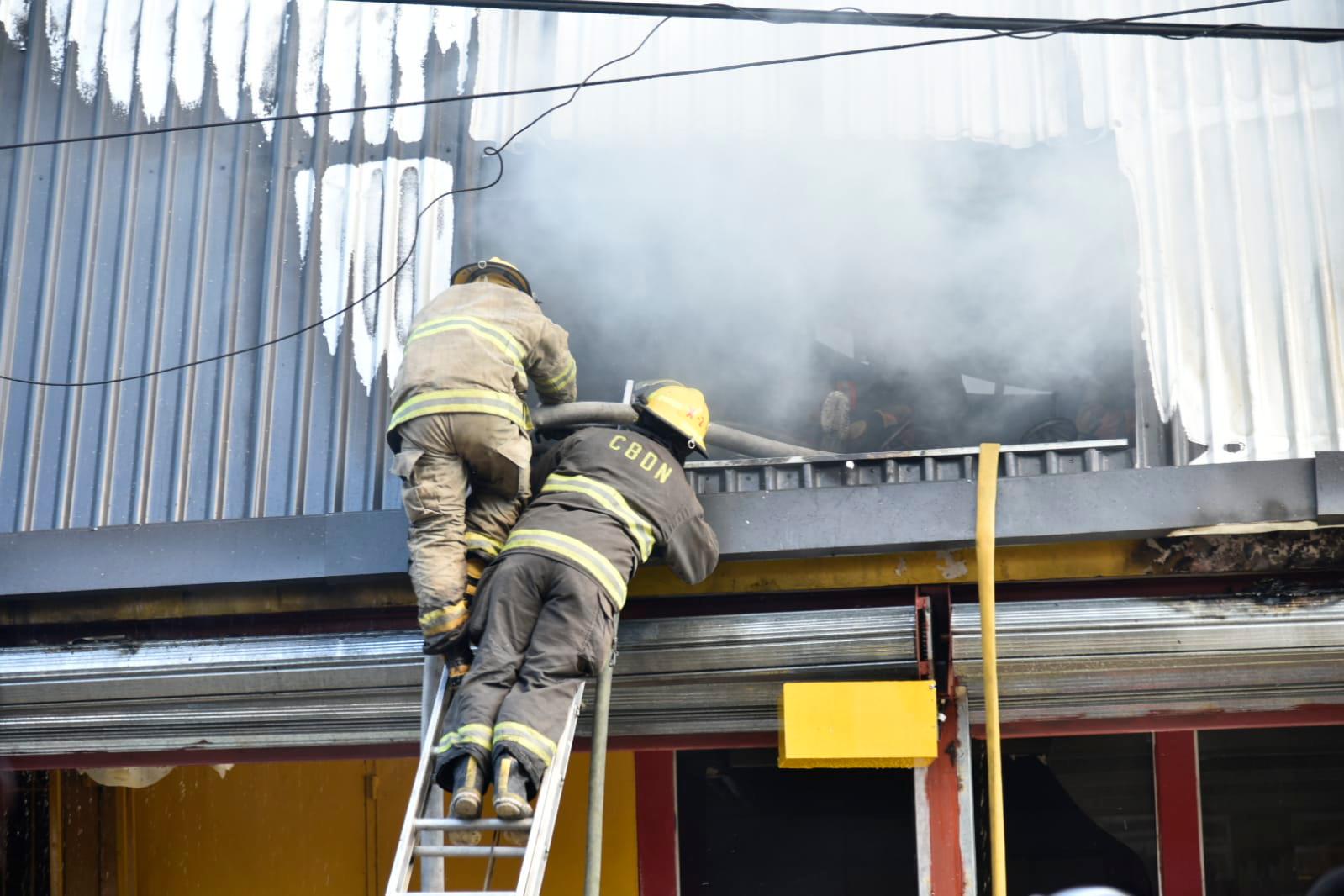 Bomberos del Distrito Nacional trabajando para sofocar incendio que afectó tienda principal de Aro y Pedal.