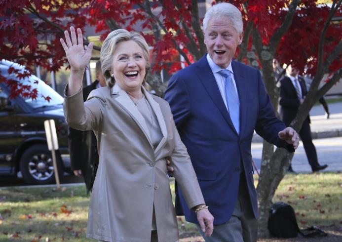 La candidata presidencial demócrata, Hillary Clinton, y su esposo, el expresidente Bil Clinton, saludan a simpatizantes, después de votar en Chappaqua, Nueva York, este 8 de noviembre de 2016.